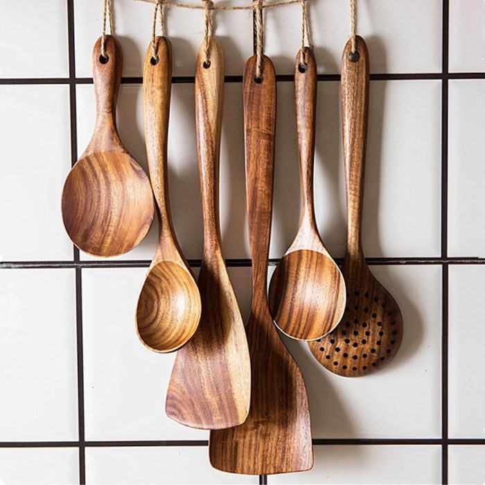 Natural wood kitchen utensil set with spoon, ladle, turner, colander, and skimmer in a storage box